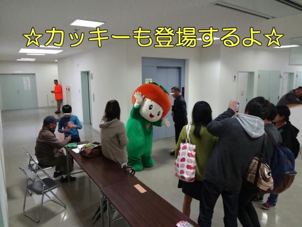 ゆるキャラかっきーが受験者の前でポーズをとっている写真